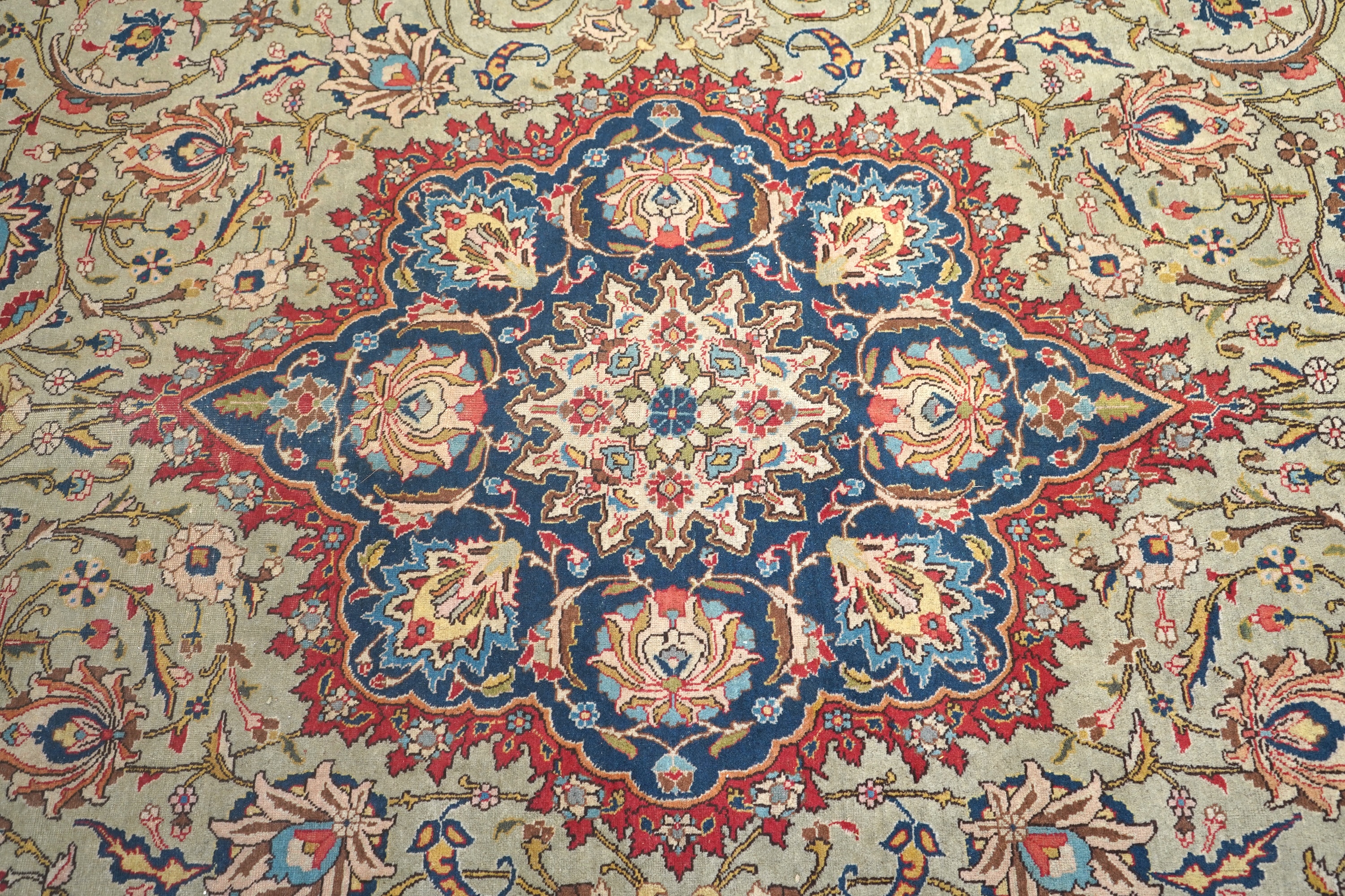 An early 20th century Tabriz pale green ground carpet